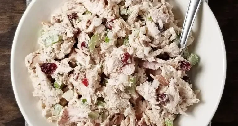 Chicken Salad Recipe: A bowl of creamy chicken salad with cranberries, celery, and nuts.