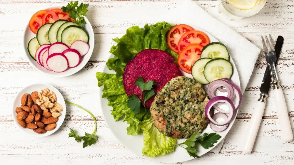 A vibrant plate showcasing "Vegan Lunch Recipes" with fresh vegetables, plant-based patties, and nuts, emphasizing healthy and colorful vegan eating.