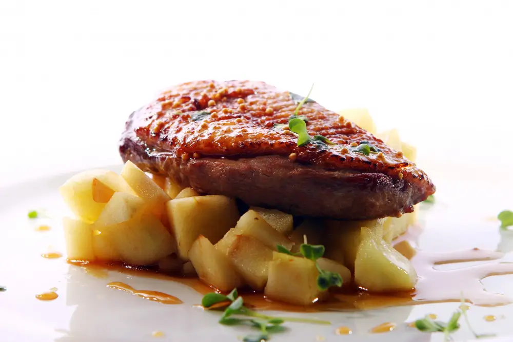 A juicy steak seasoned with Cheese Steak Seasoning, served on a bed of diced potatoes with a savory sauce.