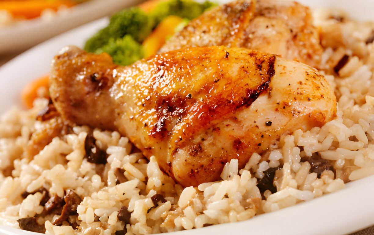 A close-up of Chicken Fried Rice, featuring tender chicken pieces atop a bed of savory rice mixed with vegetables.